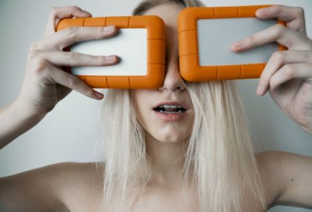 External Storage - woman holding two white-and-orange plastic cases