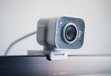 Webcam - black and silver speaker on white table