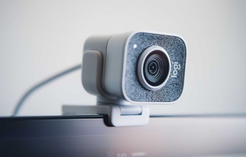 Webcam - black and silver speaker on white table