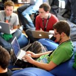 Networking Peripherals - man sitting on blue bean bag usinglaptop