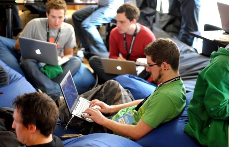 Networking Peripherals - man sitting on blue bean bag usinglaptop