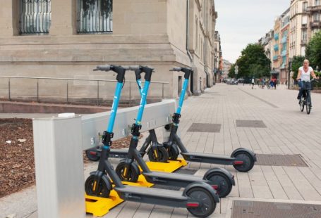 Docking Station - a row of scooters sitting on the side of a road