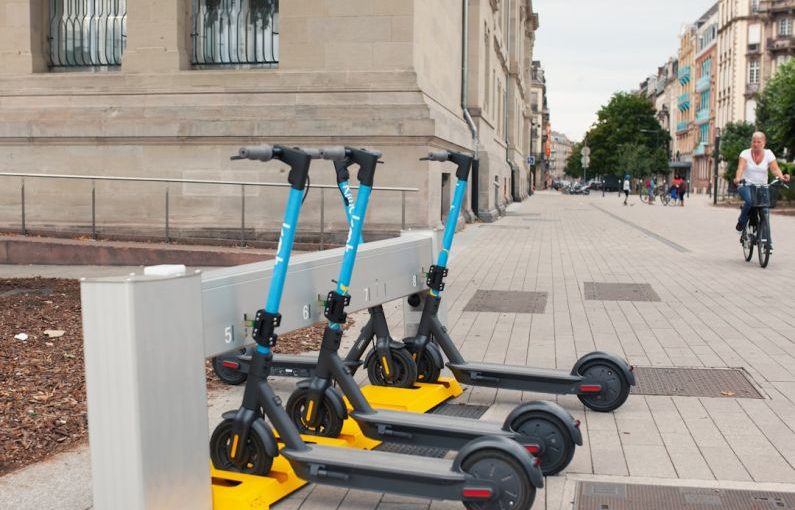 Docking Station - a row of scooters sitting on the side of a road