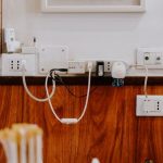 Cables Adapters - white power strip on brown wooden floor