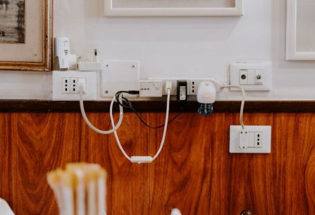 Cables Adapters - white power strip on brown wooden floor