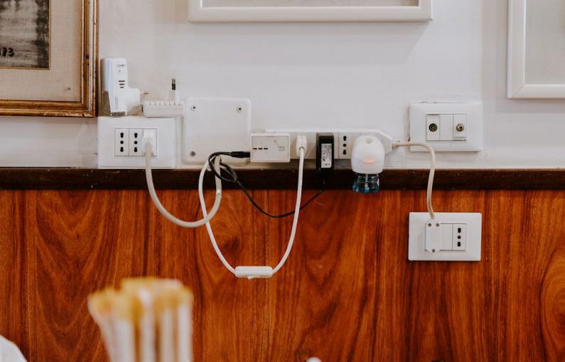 Cables Adapters - white power strip on brown wooden floor