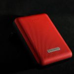 Power Bank - red leather case on black surface