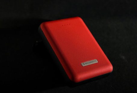 Power Bank - red leather case on black surface