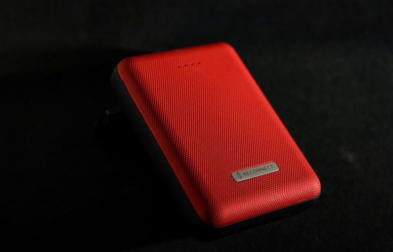 Power Bank - red leather case on black surface