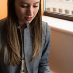 Remote Access - Photo of Woman Sitting on Chair and Typing on Silver Macbook