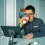 Retrofit Monitor - man in black and white checkered dress shirt drinking from brown and white ceramic mug