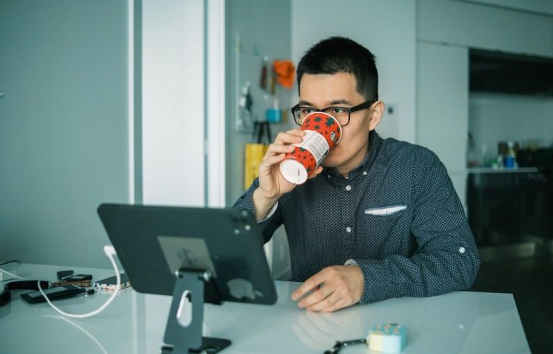 Retrofit Monitor - man in black and white checkered dress shirt drinking from brown and white ceramic mug