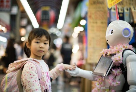 Robot - photo of girl laying left hand on white digital robot