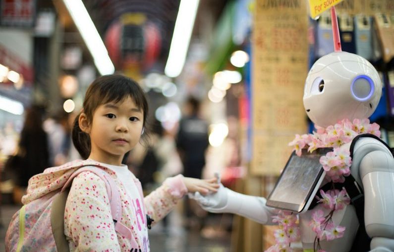 Robot - photo of girl laying left hand on white digital robot