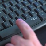 Silent PC - a person pressing a button on a keyboard