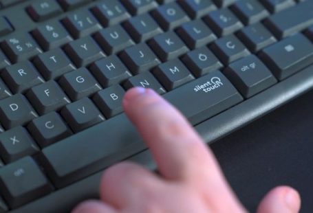 Silent PC - a person pressing a button on a keyboard