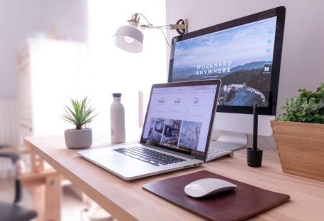 Network Setup - MacBook Pro on table beside white iMac and Magic Mouse