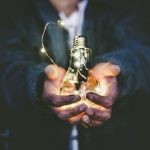 Energy-efficient - man holding incandescent bulb