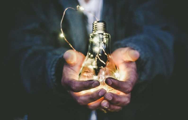 Energy-efficient - man holding incandescent bulb