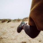 Fast Boot - person walking on sandy ground