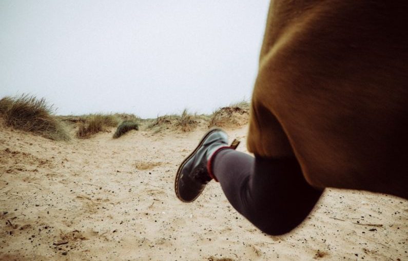 Fast Boot - person walking on sandy ground