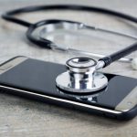 Troubleshooting - a smart phone with a stethoscope on top of it