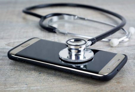 Troubleshooting - a smart phone with a stethoscope on top of it