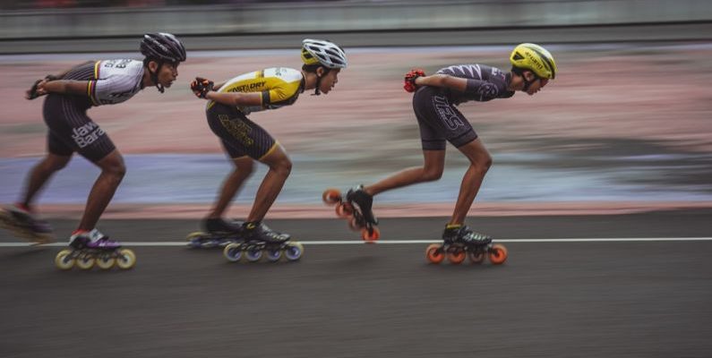 High-speed Internet - man in blue tank top and yellow helmet riding on orange and black motorcycle