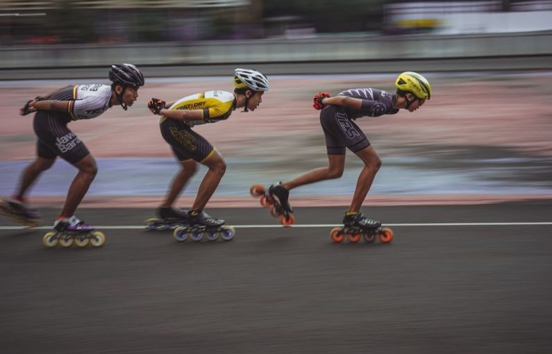 High-speed Internet - man in blue tank top and yellow helmet riding on orange and black motorcycle